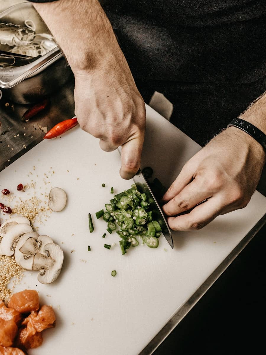 Hands preparing fresh ingredients on a chef's board