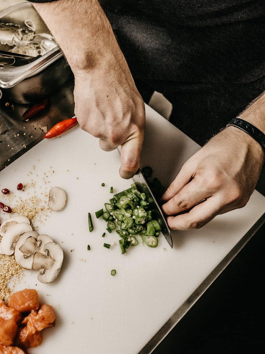 Chef plating a dish by candlelight — the craft behind fine dining